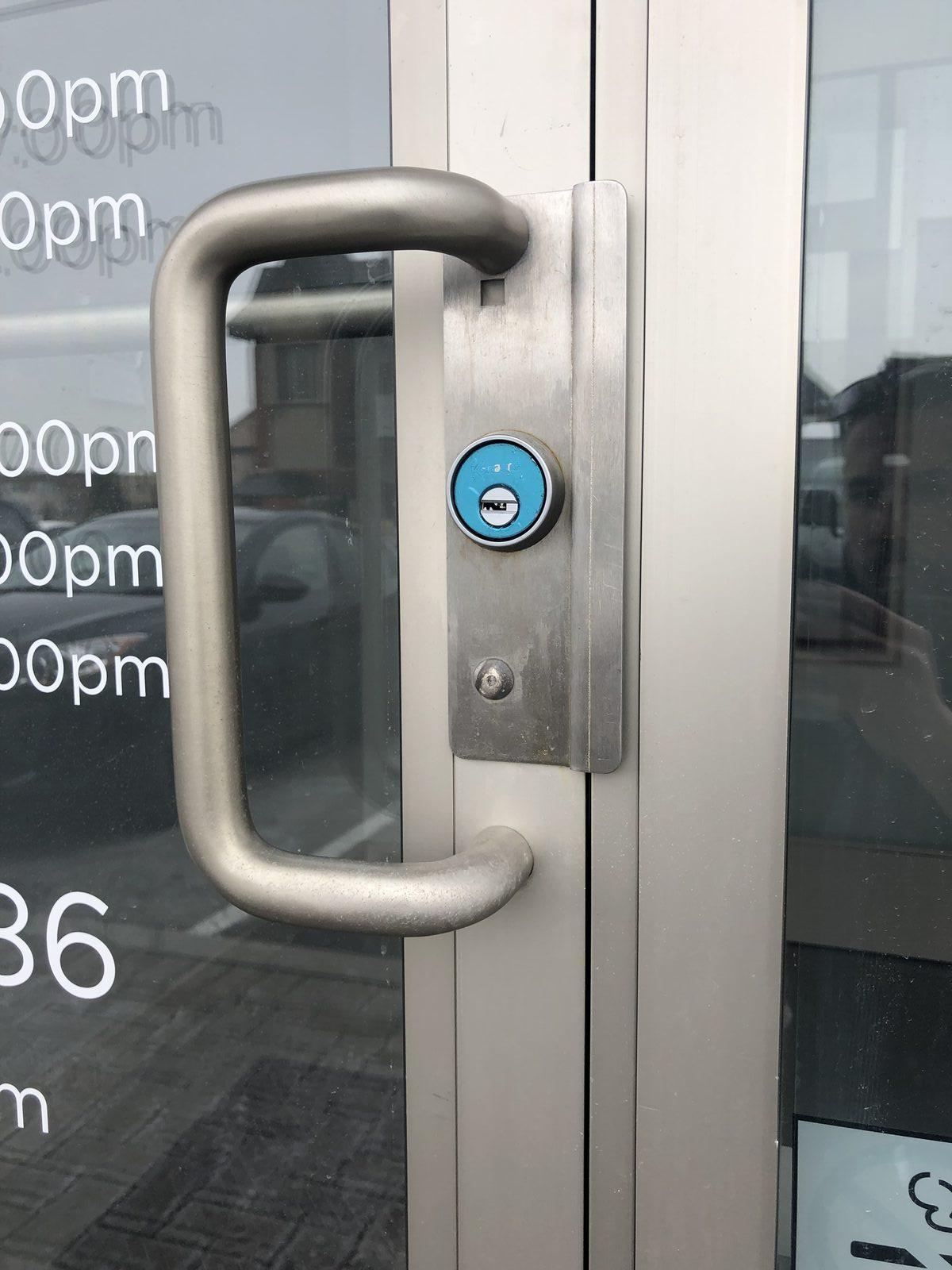 Commercial storefront door lock and thumbturn on an aluminum glass entry