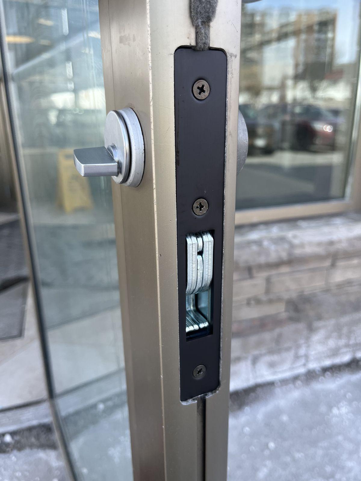 Commercial mortise lock on a glass storefront door